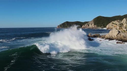 Aerial View of Motion Waves Crashing Against Rocks Ocean's Power Waves Relentlessly Meet Rocks Dance