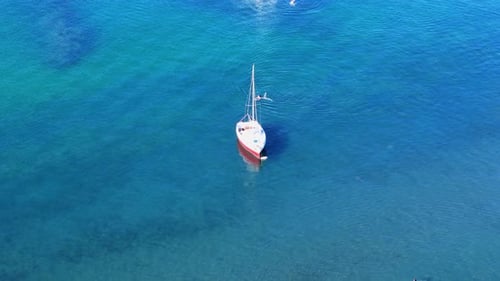Sailboat in Ocean Water on a Sunny Day