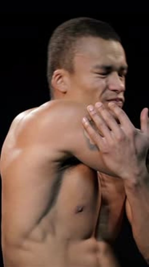 Muscular Man Massaging His Shoulder in Pain