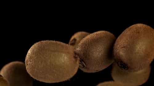 Fresh Kiwi Fruit Rotating on a Black Background