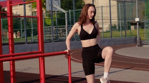 Woman Stretching Leg Muscles Outside on Sunny Day