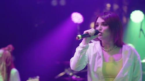 Popular Singer Woman is Performing During Rock or Hiphop Concert Portrait on Stage During Gig
