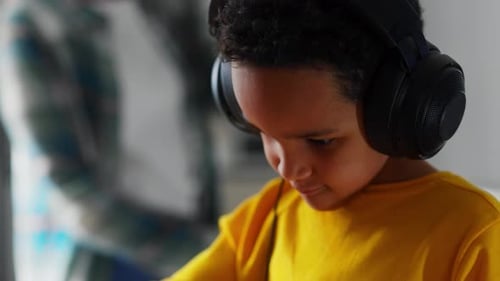 Young Boy Playing with Audio Mixing Board