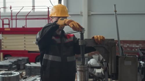 Industrial Engineer Working with Machine at Factory