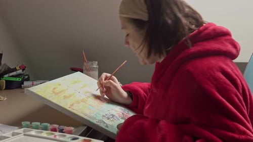 Female with brush drawing. Paint by numbers close up.