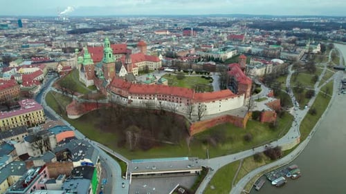 Establishing dolly shot reveal aerial over Wawel Royal Castle by the river Vistula in the city of Kr