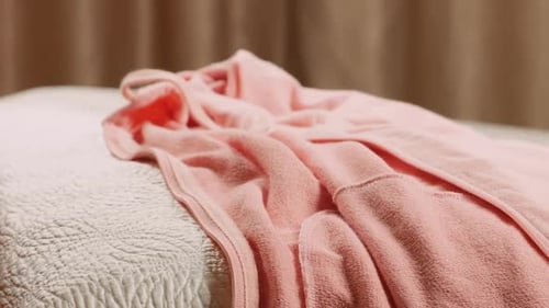 Folded Clothes Stacked on Bed Indoors