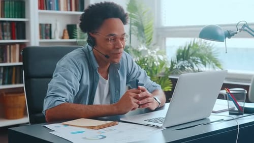 Young Adult Working Remotely in Home Office