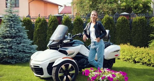 Young Woman Posing with Three-Wheeled Motorcycle