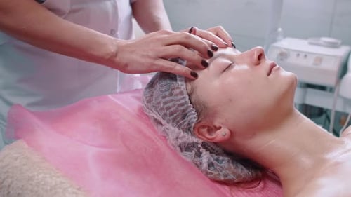 Woman Receiving a Relaxing Facial Massage Treatment