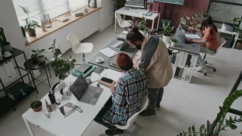 Time Lapse of Diverse Team of Programmers Working on Projects in Office