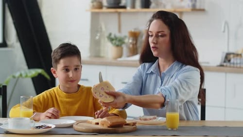 Mother and Child Share Cheerful Breakfast at Home
