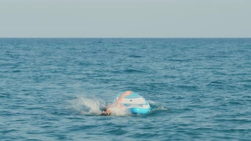 Boy Falls From Stand Up Paddle Board in the Ocean