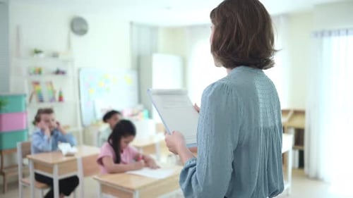 Teacher and students, Learn and study in a classroom of school where youngsters sit and listen