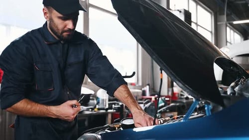 Transport is being repaired. Mechanic working in a car service station.