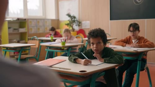 Four Multiracial Diversity Pupils Children Kids Back to School Studying in Class Lesson Learning