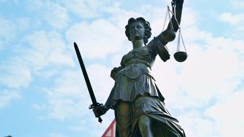 The Fountain Of Justice located in the Roemerberg, Frankfurt, Germany. Buildings on the background