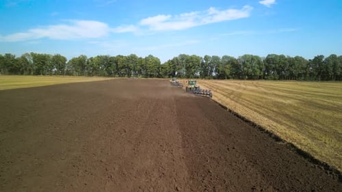 Tractors plowing the field in Ukraine