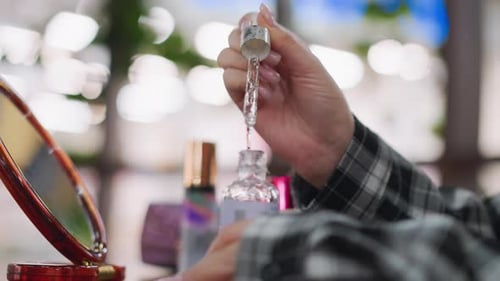 Closeup View of Hand Pouring Serum Back Into Bottle
