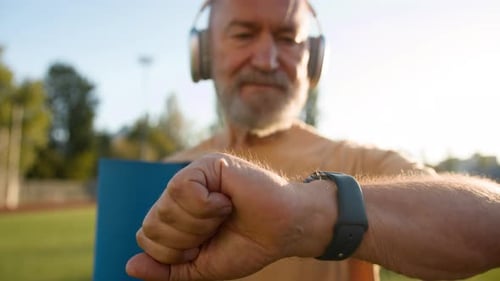 Pensioner Looking at Wristwatch End of Training Old Caucasian Man Leaving After Sport Physical