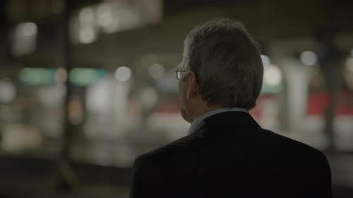 Man with Gray Hair Wearing Glasses at Night