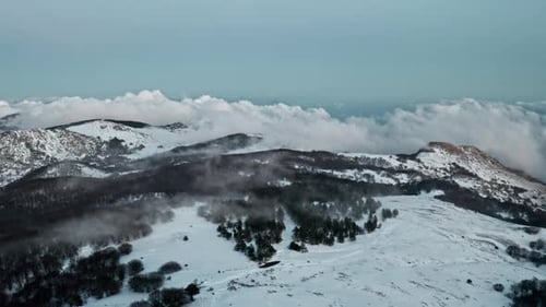 Snowy Mountains Aerial View with Clouds and Tower