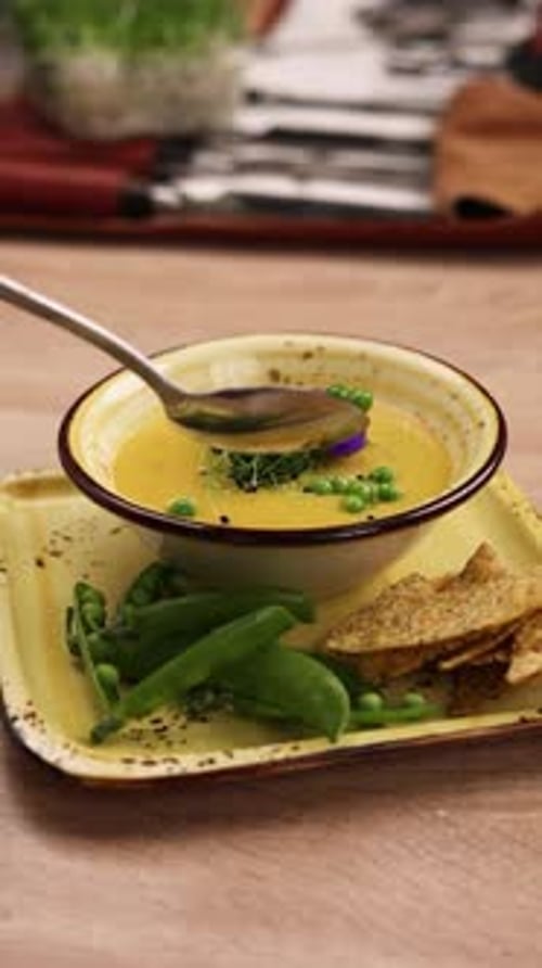 The chef is preparing a puree soup in the kitchen. Close-up