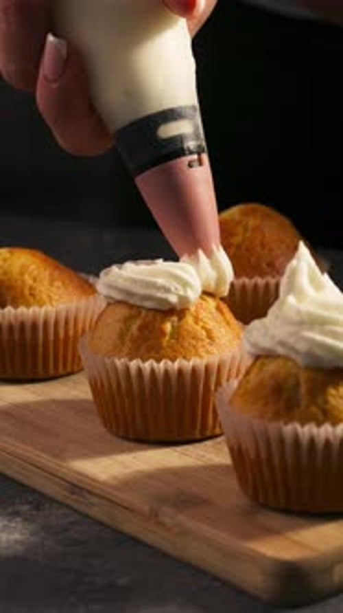 Vertical Of Cupcakes Topped With Whipped Cream Frosting. Close-up Shot