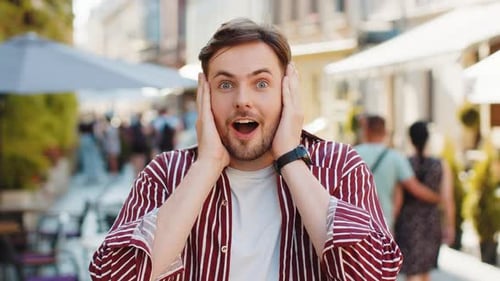 Adult Man Looking Surprised at Camera Shocked By Sudden Win Good Victory News Wow in City Street