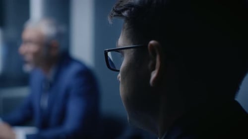 Business People Attending Meeting in Modern Dark Office
