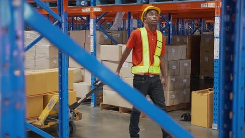 Young man pull and move cargo for transportation and distribution in the warehouse at factory.