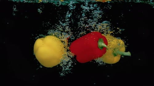 Bell Peppers Splashing into Water in Slow Motion