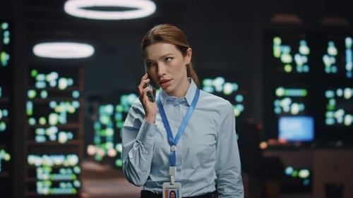 Woman Talking on Phone in Front of Screens