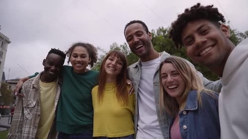 Smiling Friends Embrace in Urban Setting