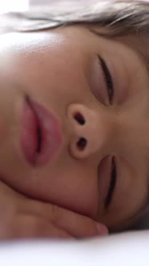 Serene close-up of a child in deep sleep, highlighting the innocence and peacefulness of childhood