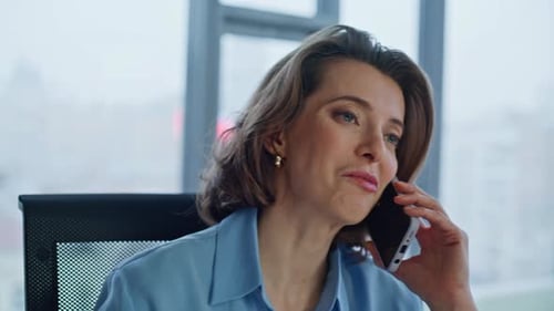 Woman Talking on Cell Phone in Office