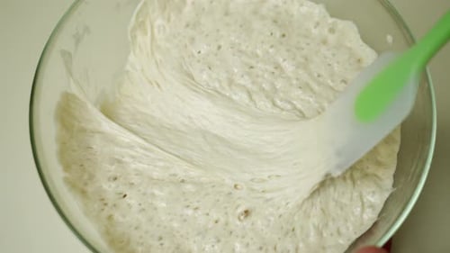 Close Up Sourdough Starter Being Mixed with Spatula