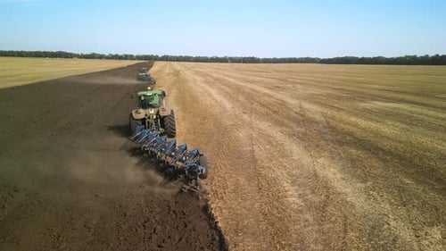 Tractors plowing the field in Ukraine