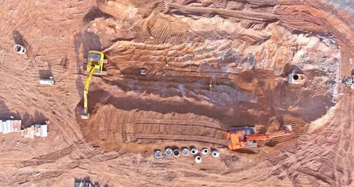 Construction Site with Heavy Equipment Excavating Earth