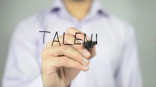 Hand Writes Word Talent on Transparent Surface