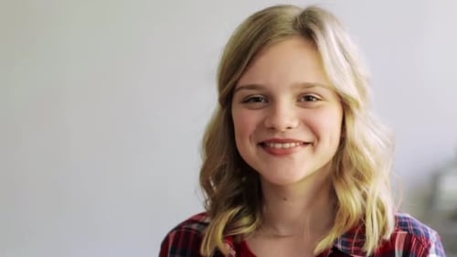 Teenage Girl Smiling and Laughing in an Indoor Setting