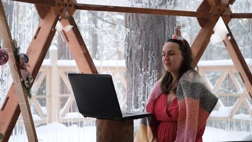 Cheerful Woman Video Calling During Winter Holiday