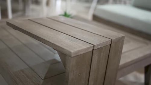 Wooden outdoor furniture on patio in neutral colors