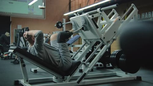 Man Doing Leg Press in Gym For Fitness
