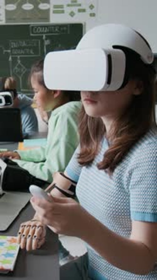 Girl with Prosthetic Arm Using Remote Controller for VR Headset in School