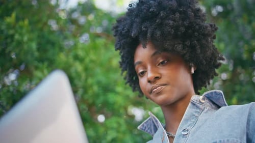 Woman Working on Laptop in Urban Nature Setting