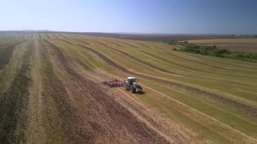 Tractor working on the field doing tillage with cultivator