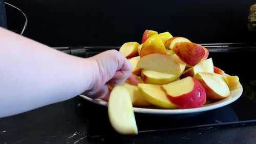 Apple Slices Piled High on a White Plate