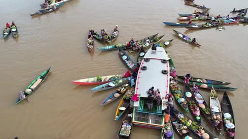 Traditional Lok Baintan floating market with local merchants on wooden boats in Banjarmasin