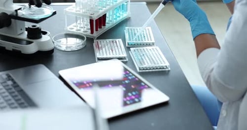 Lab Worker Using Pipette for Scientific Research